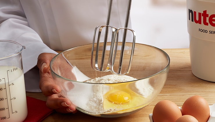 Banana cooked crepes with Nutella® and nuts