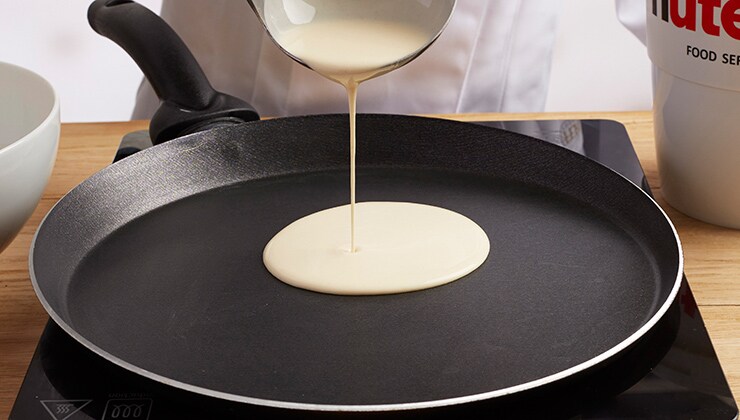 Banana cooked crepes with Nutella® and nuts