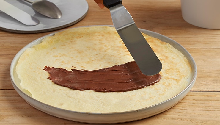 Banana cooked crepes with Nutella® and nuts