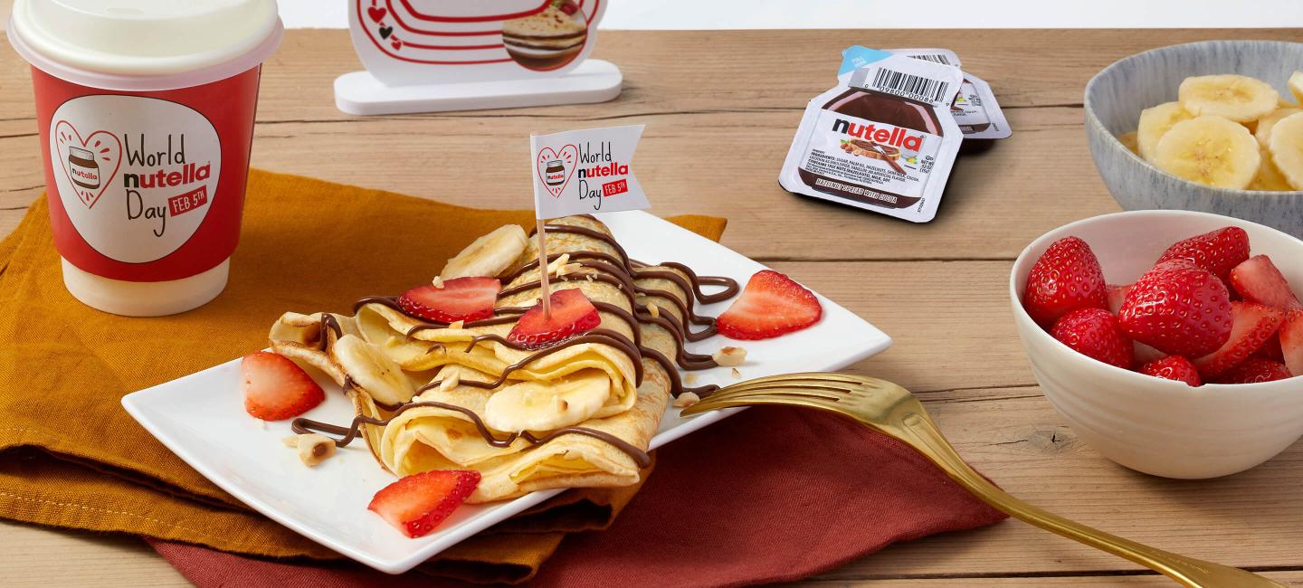 Banana cooked crepes with Nutella® and nuts