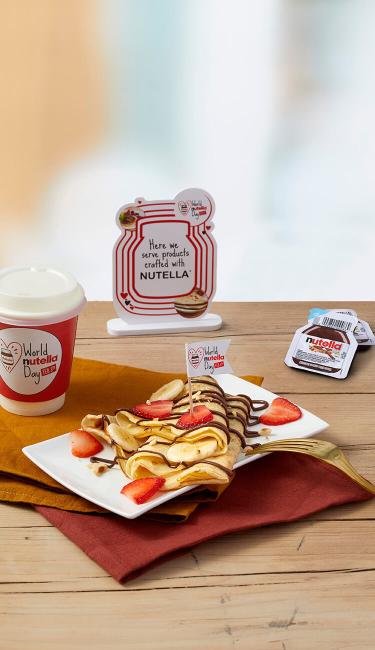 Banana cooked crepes with Nutella® and nuts