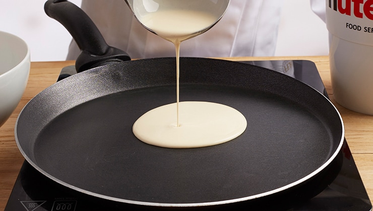 Banana cooked crepes with Nutella® and nuts